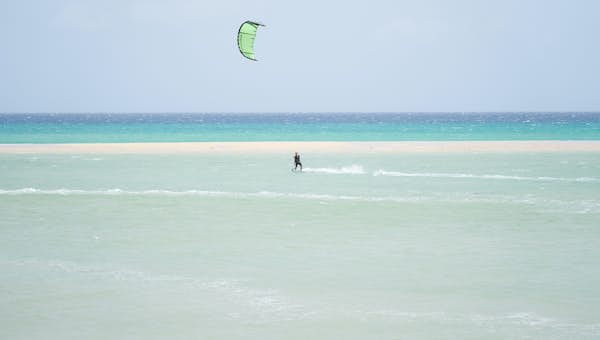 A person is kitesurfing 
