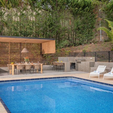 A swimming pool in a backyard.  A swimming pool in a backyard.