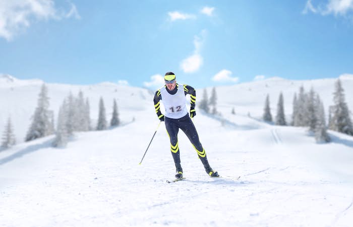 A man on skis on a snowy slope.