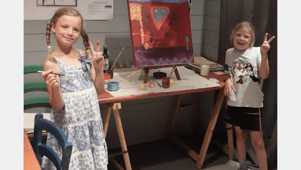 Two girls posing for the camera during an art activity in Les Arcs
