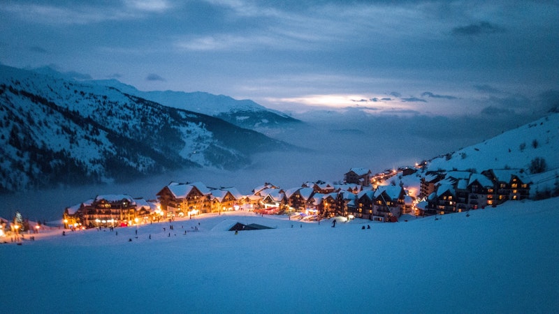 Nighttime shot of Alpine town during skiing holidays in French Alps