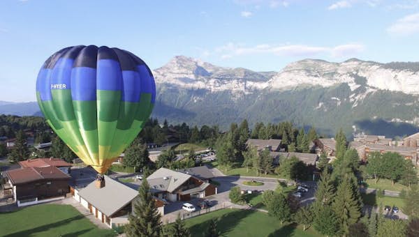 Hot Air Balloon flying Les Carroz mountain views 