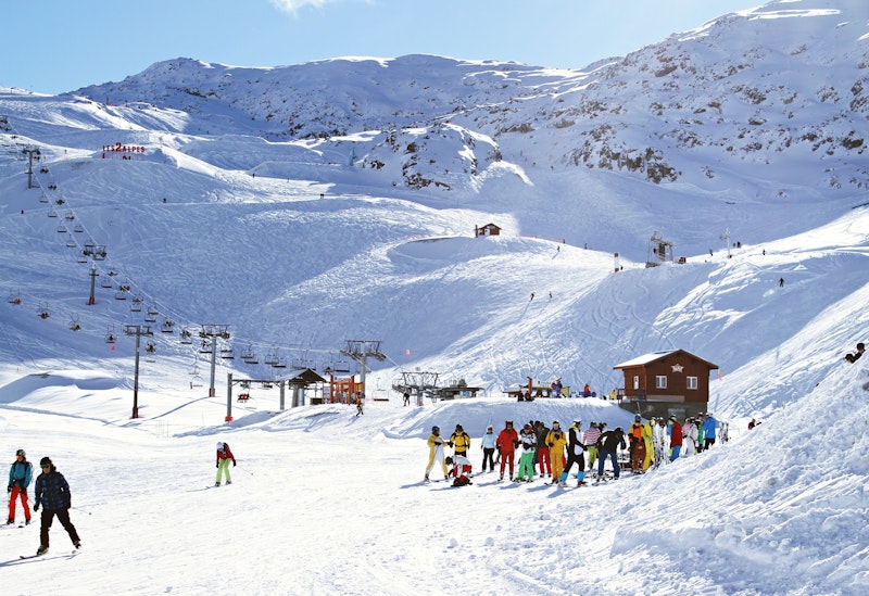 Group of skiers at the bottom of a slope during ski holidays in French Alps Group of skiers at the bottom of a slope during ski holidays in French Alps