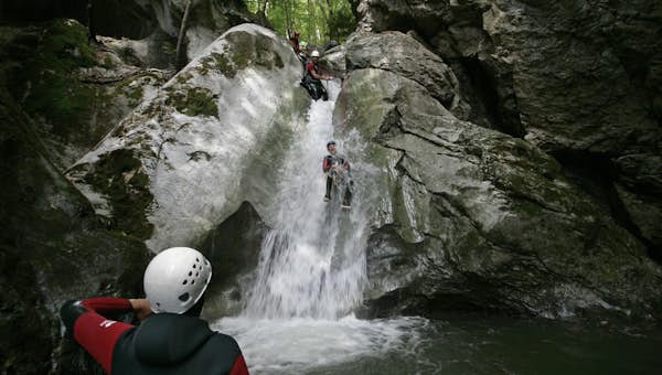 Tourists whitewater canyoning Les Carroz