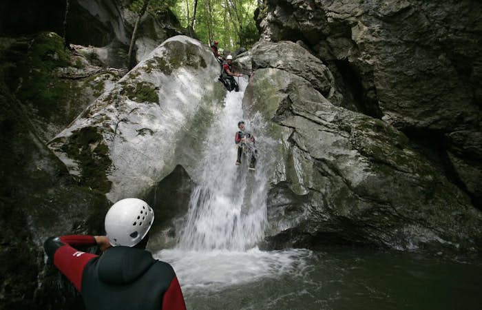 Tourists whitewater canyoning Les Carroz