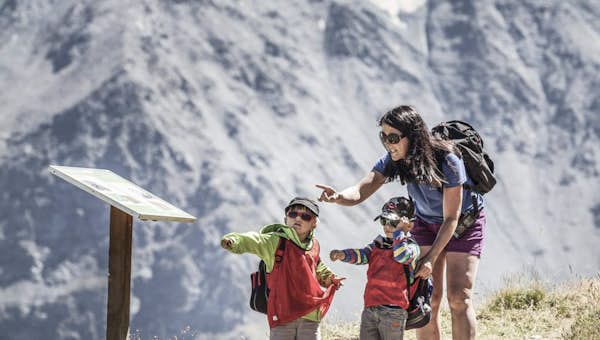 A mother and two children taking part in an orienteering session in Les Arcs