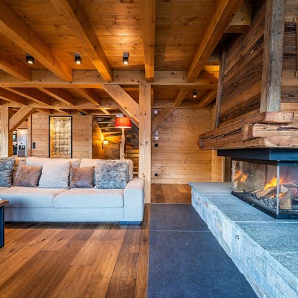 A chalet living room with a fireplace.